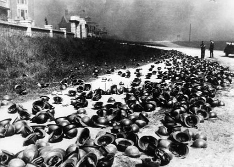 German soldiers examine helmets left on the beach by British and French soldiers near Dunkirk, 1940