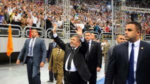 Egyptian President Mohammed Morsi waves as he arrives at a rally called for by hardline Islamists loyal to the Egyptian president to show solidarity with the opposition in Syria, in a stadium in Cairo, Egypt, Sunday, June 15, 2013. (AP / Egyptian Presidency)