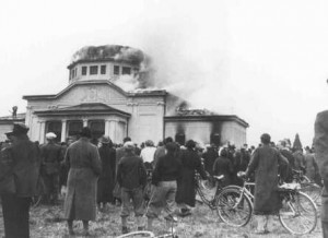 Local residents watch the burning of the ceremonial hall at the Jewish cemetery in Graz during Kristallnacht, November 1938