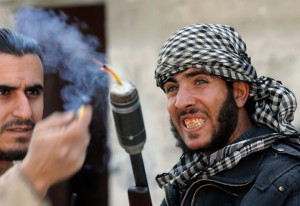 ighters from the Free Syrian Army’s Tahrir al Sham brigade light the fuse of an improvised grenade, ready to launch it from a modified shotgun, toward Syrian Army soldiers in the Arabeen neighborhood of Damascus, on February 9, 2013. (Reuters/Goran Tomasevic) 