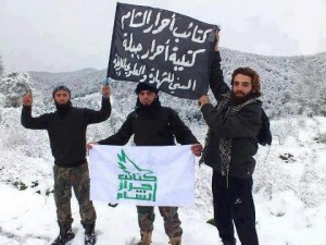The black sign includes the words “Genocide for Alawites.” The long unkept beard with shaven upper lip (see two men on left) is a tell-tale Wahhabi/Salafi look.