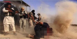 Islamic State of Iraq and the Levant militants executing members of the Iraqi forces on the Iraqi-Syrian border.