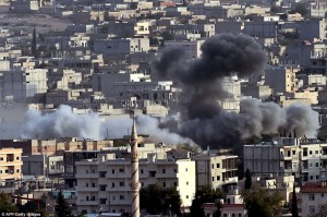 Smoke from an airstrike by the US-led coalition ascends in the Syrian town of Ain al-Arab, known as Kobane by the Kurds. 