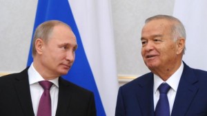 Russian President Vladimir Putin (L) and Uzbek President Islam Karimov attend a meeting at Kuksaroy residence in Tashkent on December 10, 2014. 