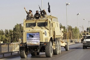 ISIS fighters arrive in Ar-Raqqah, Syria on board of American supplied ex-Iraqi army vehicles.