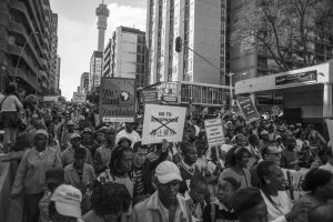 People hold up signs during a large anti-xenophobia rally in Johannesburg which was attended by thousands who marched through the city demanding an end to the violence against foreigners in South Africa.