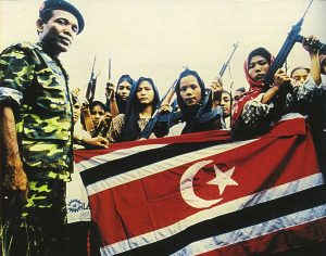 Women soldiers of the Free Aceh Movement with GAM commander Abdullah Syafei'i, 1999