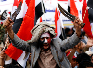 A man waves traditional daggers, or Jambiyas, as he attends with supporters of the Houthi movement and Yemen's former president Ali Abdullah Saleh a rally to mark two years of the military intervention by the Saudi-led coalition, in Sanaa, Yemen