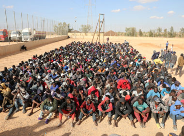 Migrants sit at a detention center in Gharyan