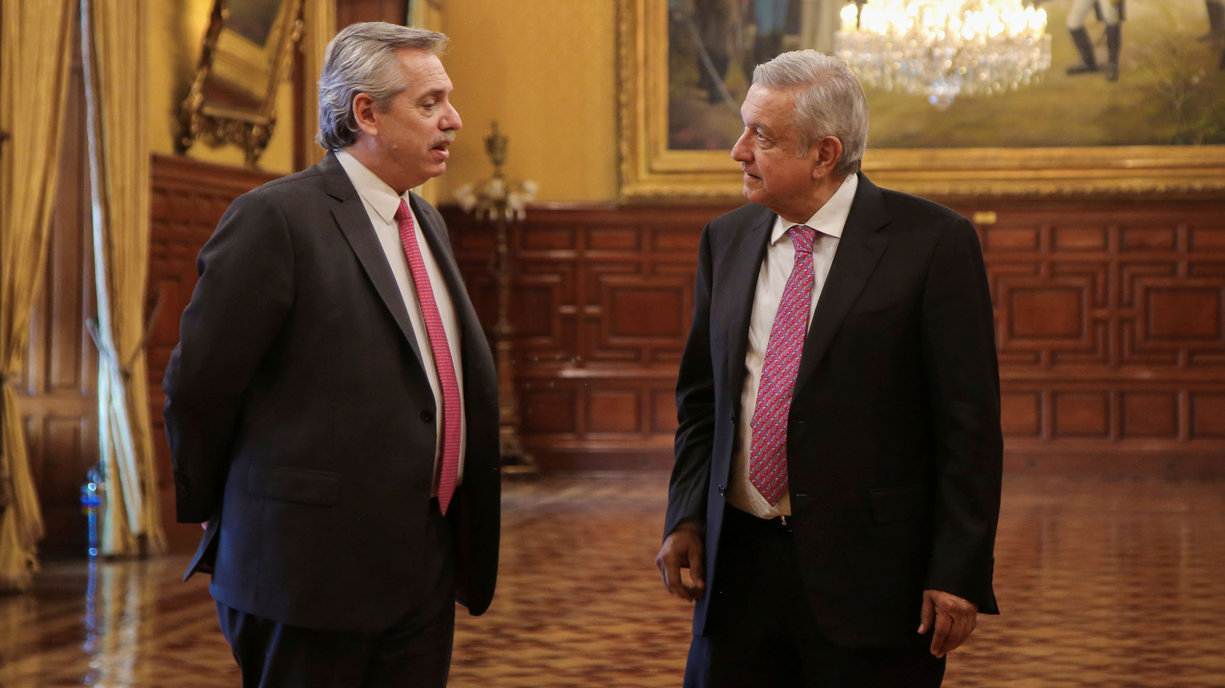 Argentina's President-elect Alberto Fernandez and Mexico's President Andres Manuel Lopez Obrador chat during a meeting at National Palace in Mexico City