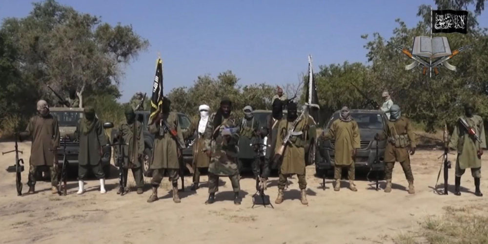 Abubakar Shekau stands at the centre of a Boko Haram video from 2014