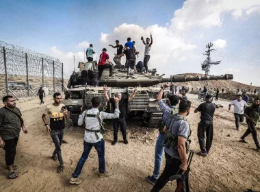 Palestinians atop a tank